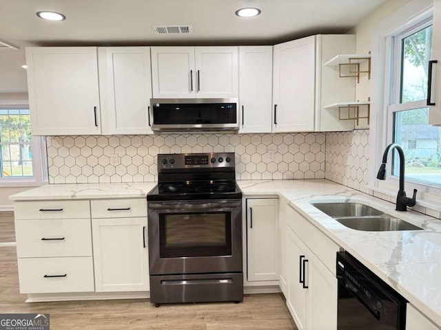 kitchen featuring appliances with stainless steel finishes, plenty of natural light, and sink