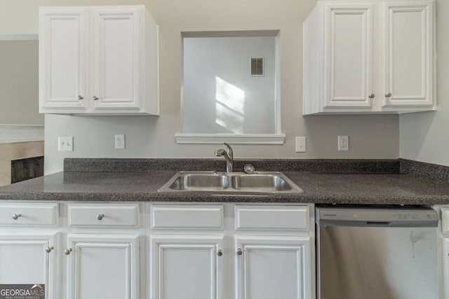 kitchen with white cabinets, dishwasher, and sink