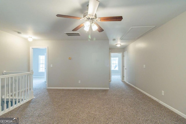 carpeted empty room featuring ceiling fan