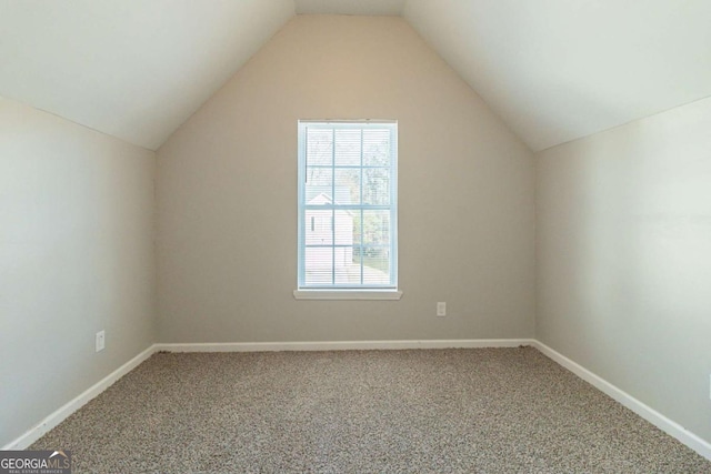 bonus room with carpet floors and vaulted ceiling