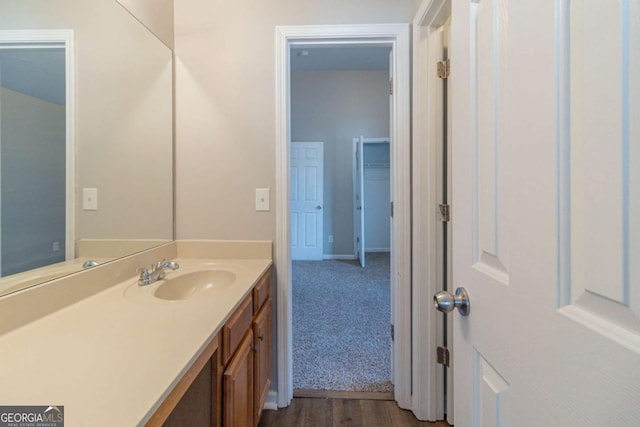 bathroom with hardwood / wood-style floors and vanity