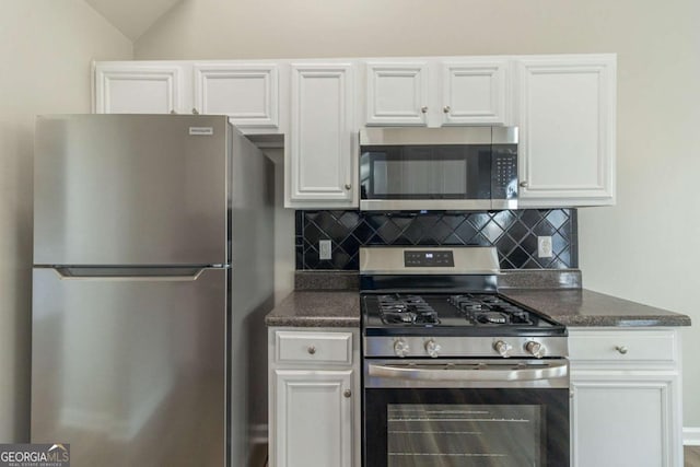 kitchen with appliances with stainless steel finishes, backsplash, and white cabinetry