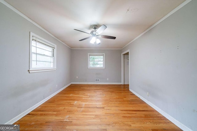 spare room with ceiling fan, ornamental molding, and light hardwood / wood-style flooring