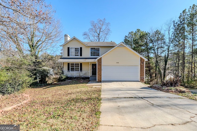 front facade with a front lawn, a porch, and a garage