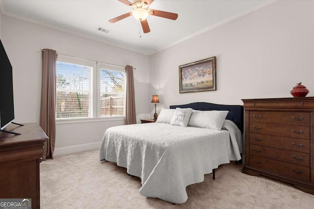 carpeted bedroom with ceiling fan and ornamental molding