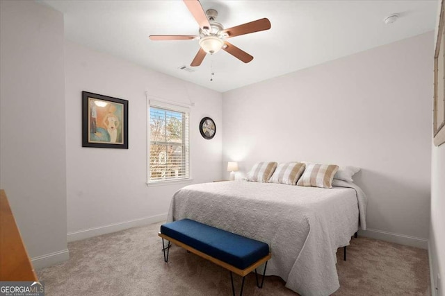 bedroom with ceiling fan and light carpet