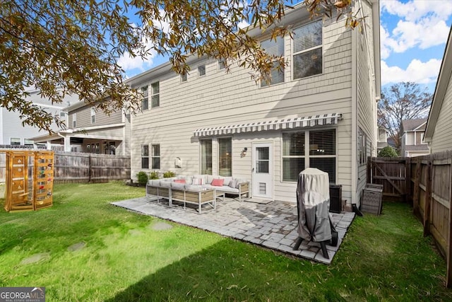 back of property featuring a patio area, a yard, and an outdoor hangout area