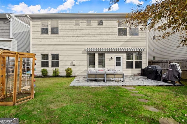 back of house with outdoor lounge area, a yard, and a patio