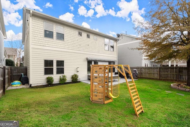 back of house featuring a playground and a lawn