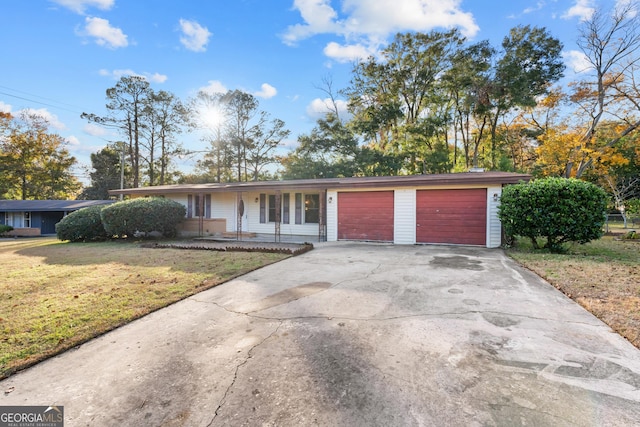 ranch-style house with a front yard and a garage