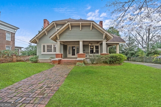 view of front of house with a porch and a front yard