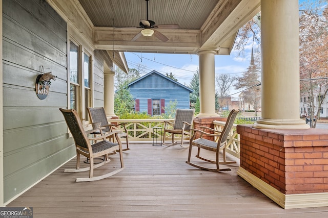 wooden deck featuring ceiling fan and a porch