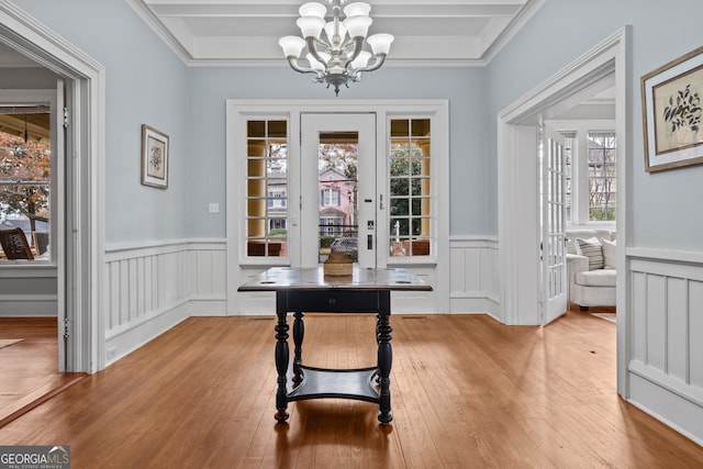 dining area featuring a healthy amount of sunlight, a chandelier, and ornamental molding