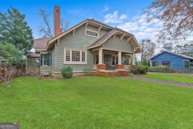 view of front of home with a front yard and a porch