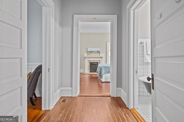 corridor with hardwood / wood-style floors