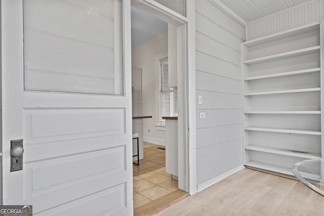 interior space featuring wood walls and wood-type flooring