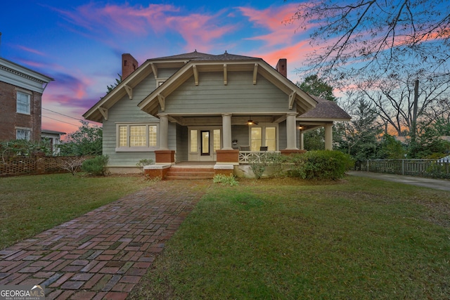 view of front of home featuring a lawn and covered porch