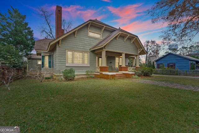 view of front of property featuring a lawn and a porch