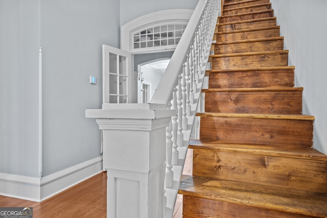 staircase featuring wood-type flooring