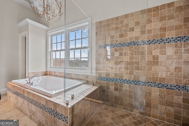 bathroom featuring tile patterned floors, a notable chandelier, and tiled tub