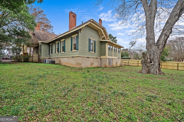 view of side of home with a yard