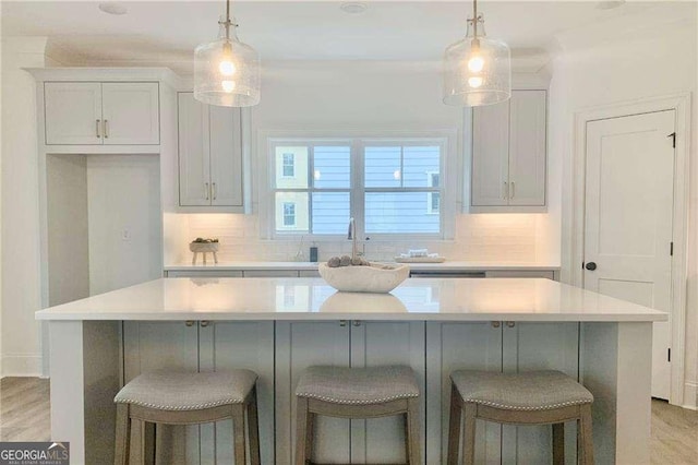 kitchen featuring a kitchen island, hanging light fixtures, and tasteful backsplash