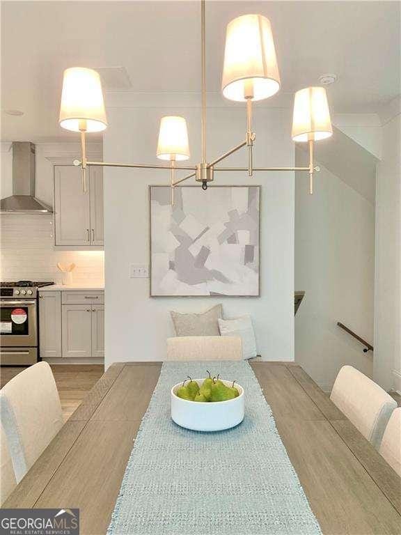 dining area featuring a notable chandelier and light hardwood / wood-style flooring