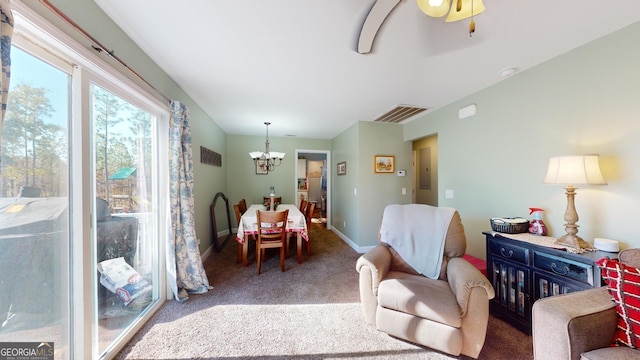 living room featuring carpet floors and an inviting chandelier