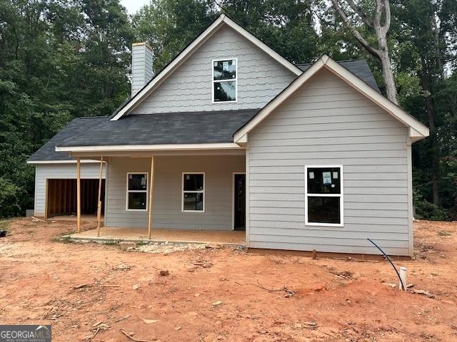 back of house featuring a porch