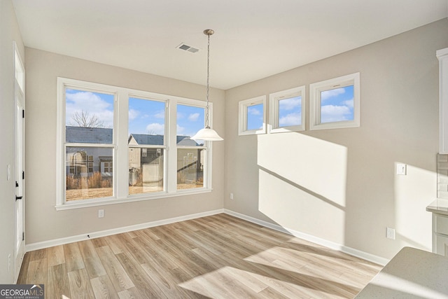 unfurnished dining area featuring light hardwood / wood-style flooring