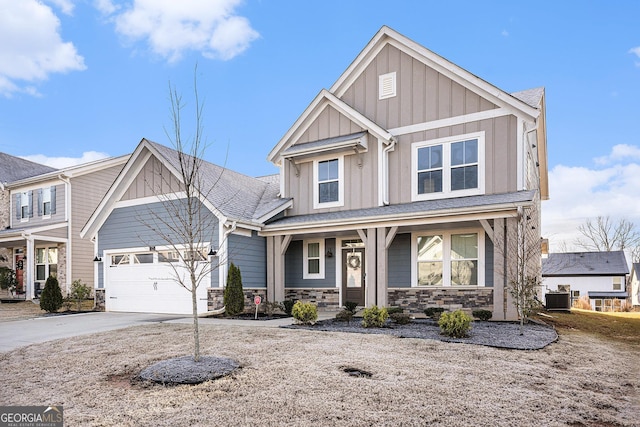 craftsman inspired home with a garage and central air condition unit