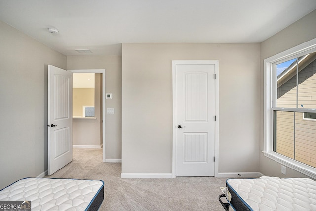 bedroom featuring light carpet