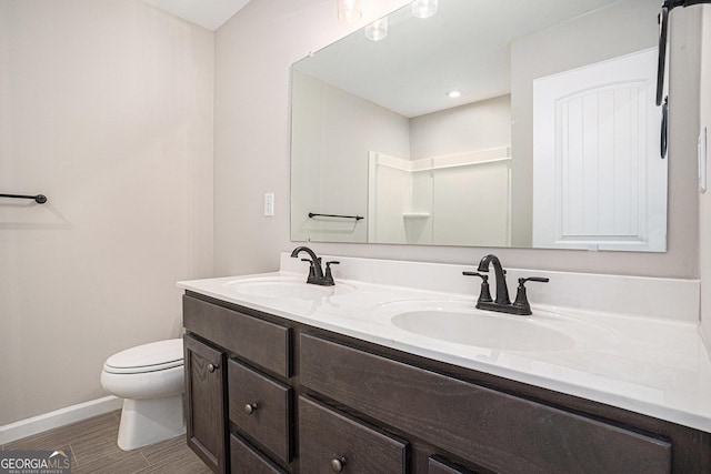 bathroom with a shower, tile patterned floors, vanity, and toilet