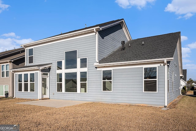 back of property with a patio and a lawn