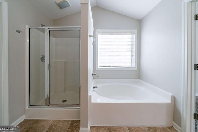 bathroom featuring plus walk in shower and lofted ceiling