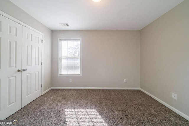 unfurnished bedroom with carpet floors and a closet