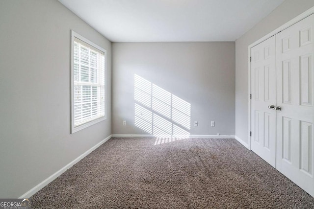 unfurnished bedroom featuring carpet floors and a closet