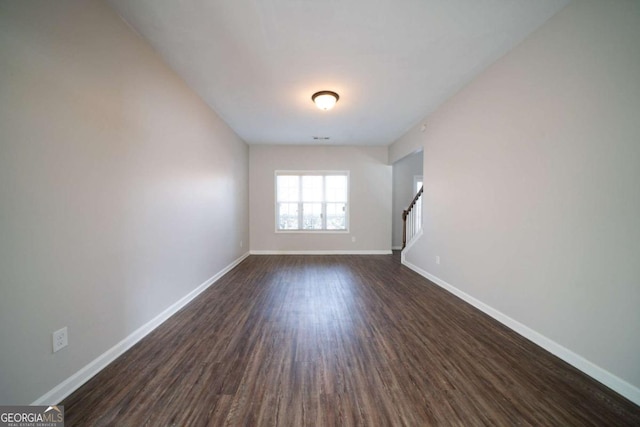 unfurnished room featuring dark hardwood / wood-style floors