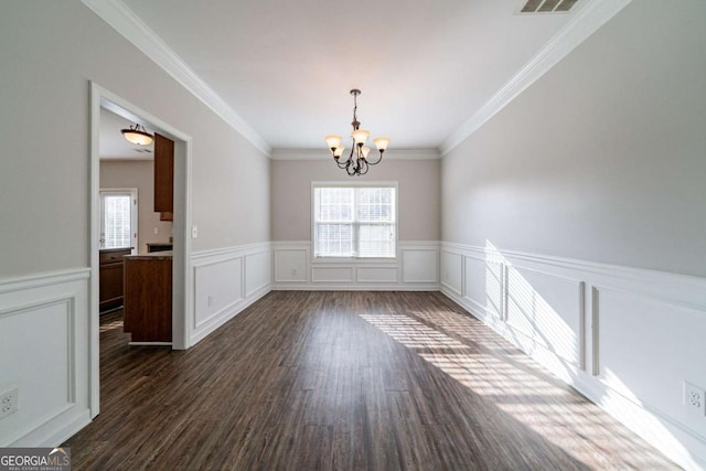 unfurnished dining area with crown molding, a chandelier, and dark hardwood / wood-style floors