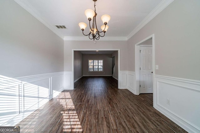 entrance foyer with a chandelier, dark hardwood / wood-style floors, and crown molding