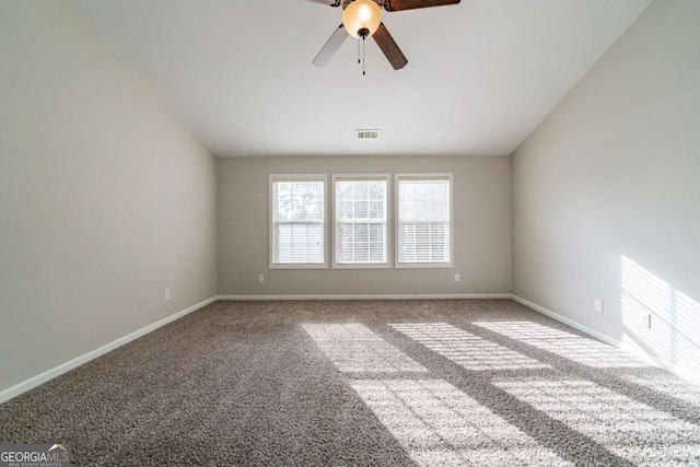 carpeted spare room with ceiling fan