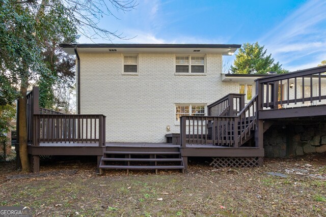 rear view of property with a wooden deck