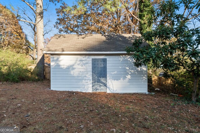 view of side of home featuring a shed