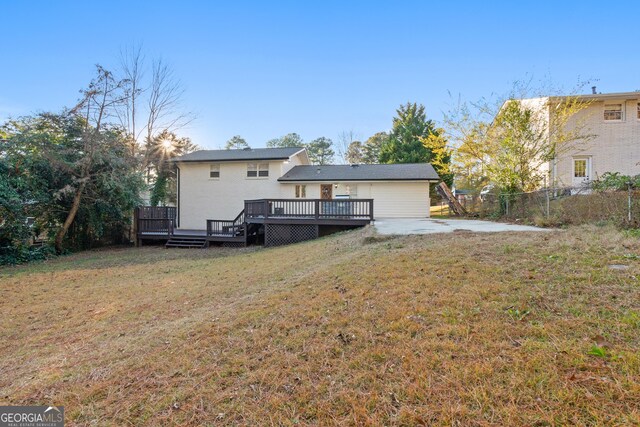 back of house with a yard and a wooden deck