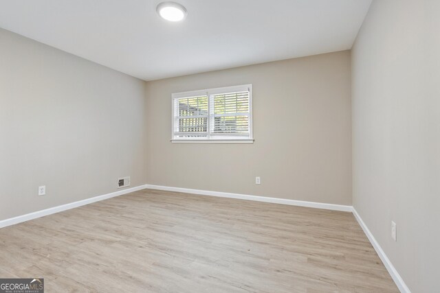 spare room with light hardwood / wood-style floors