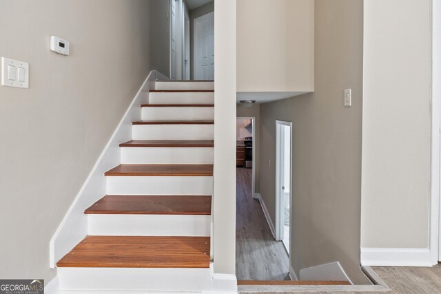 stairs with hardwood / wood-style flooring