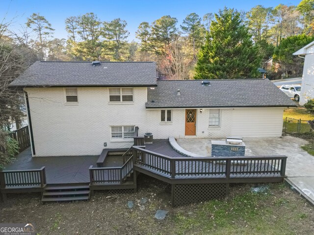 rear view of house featuring a deck and a patio area