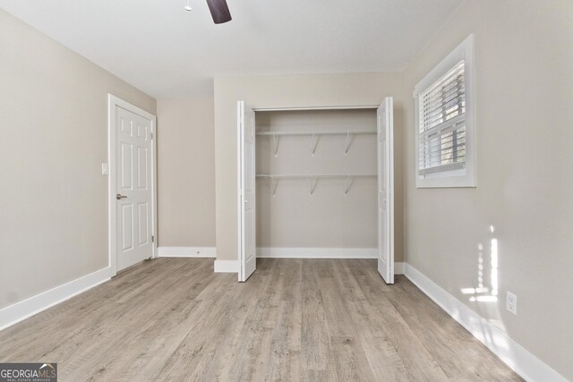 unfurnished bedroom with a closet, ceiling fan, and light hardwood / wood-style floors