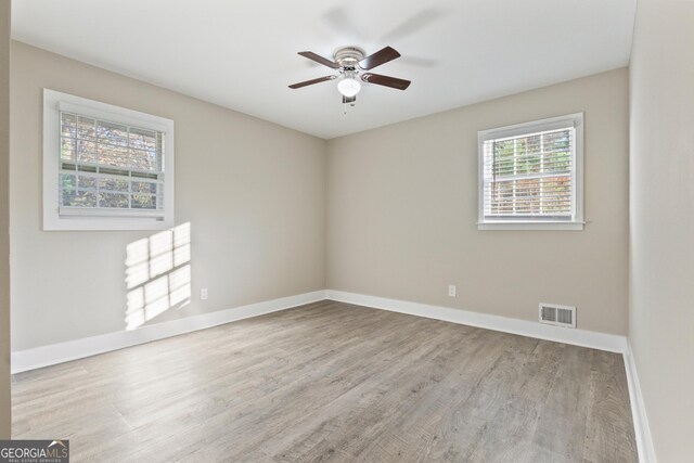 spare room with light hardwood / wood-style flooring and ceiling fan