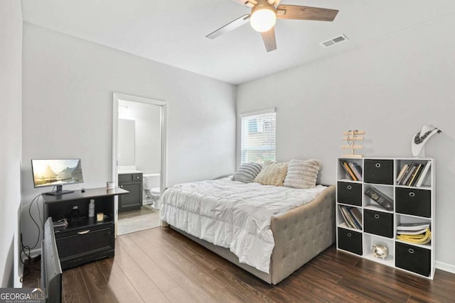 bedroom with a ceiling fan, visible vents, dark wood-type flooring, and ensuite bathroom